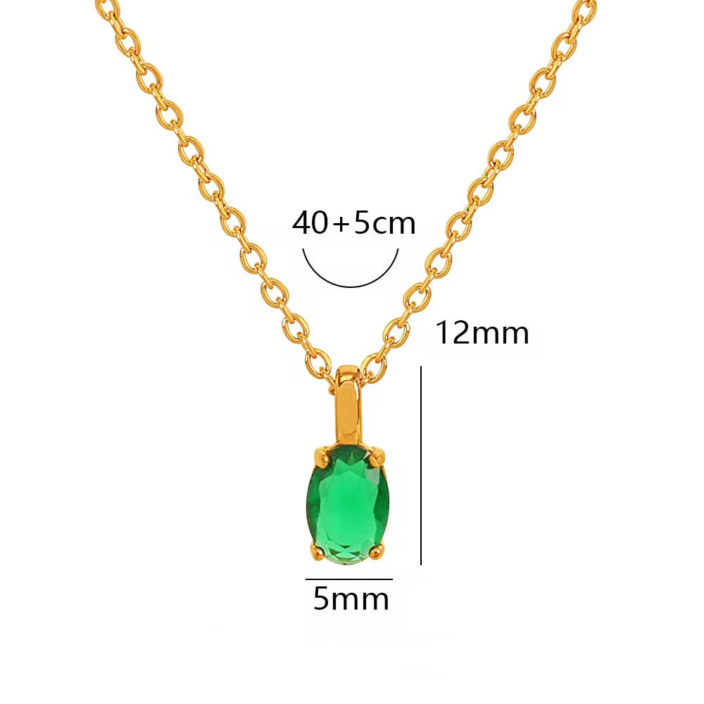 Gold necklace with a green gemstone, showing measurements and material details.