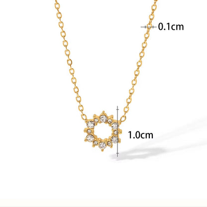 Gold necklace with circular pendant and measurements on a white background